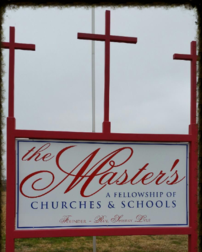 A sign for the master 's church in front of three crosses.