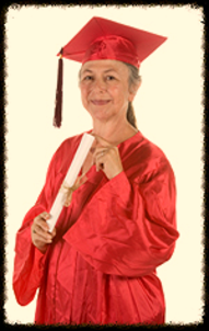 A woman in red graduation gown holding a white diploma.